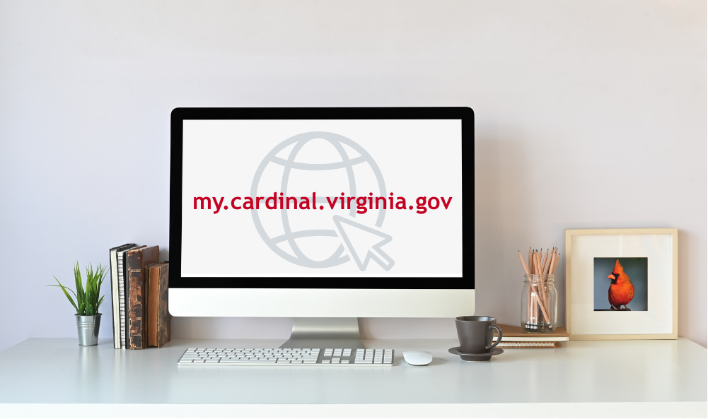 my.cardinal.virginia.gov URL typed inside a computer screen on a desk next to a picture of a cardinal